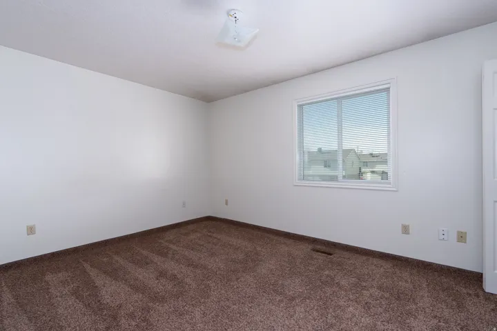 Spare room with dark carpet