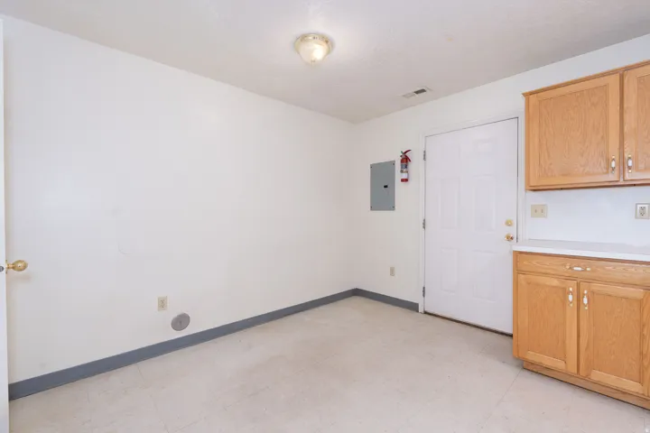 Kitchen with light floors, light countertops, and electric panel