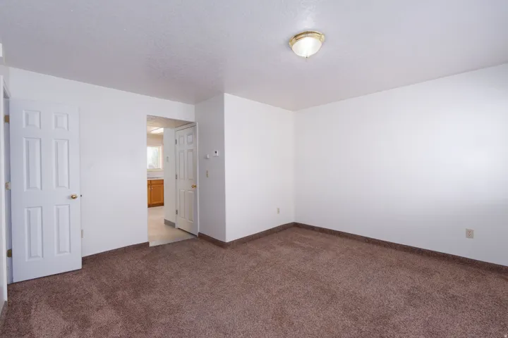 Unfurnished room with carpet flooring and a textured ceiling