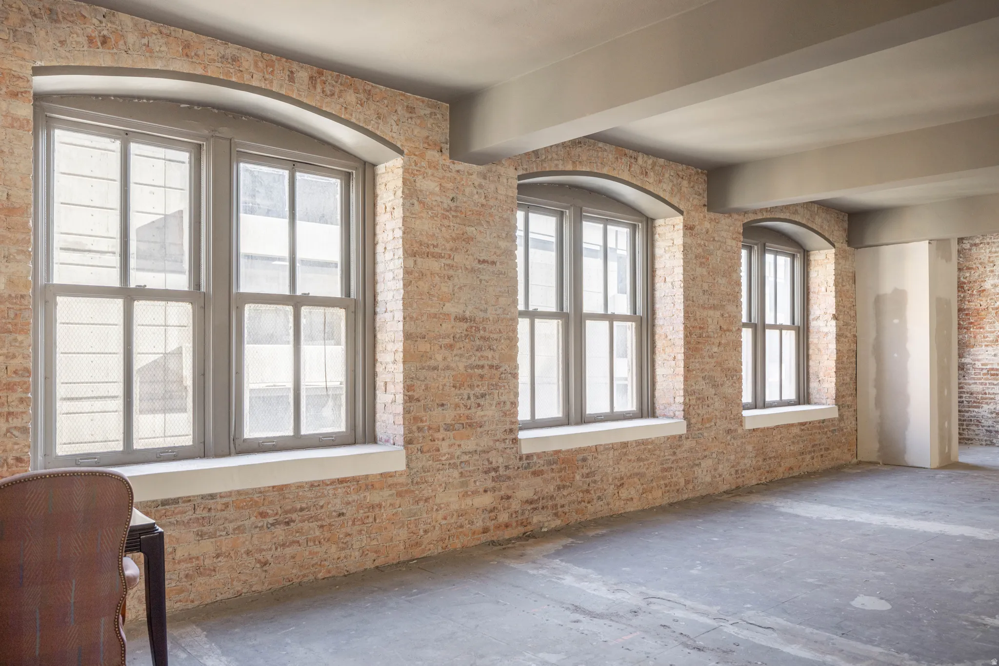 Unfurnished room with brick wall