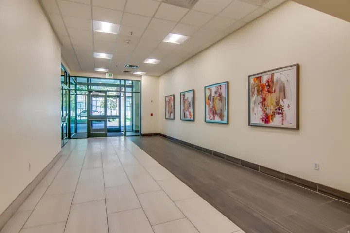 Building lobby with floor to ceiling windows and a paneled ceiling