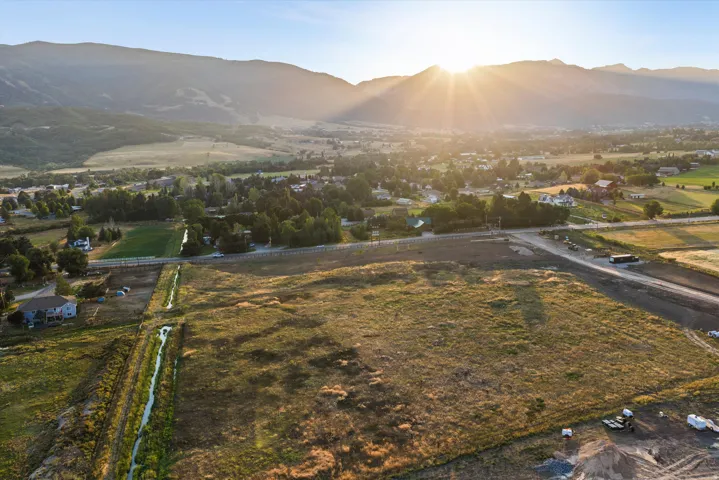 Expansive land parcel featuring open fields and distant mountains