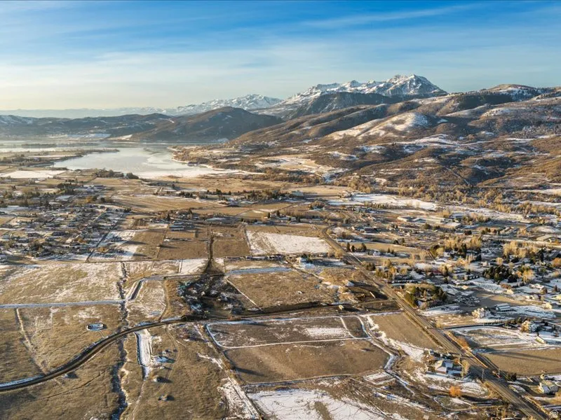 View of property location with a mountain backdrop and nearby suburban area