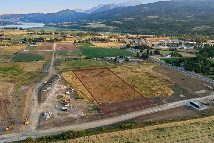 Expansive vacant land parcel with cleared and graded foundation, ready for development