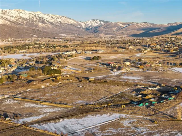 Aerial view of property's location featuring a mountainous background and rural landscape