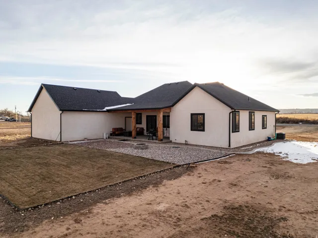 Back of house with a patio area and stucco siding
