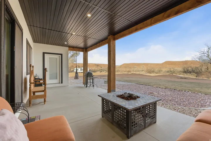 View of patio featuring an outdoor fire pit and a mountain view