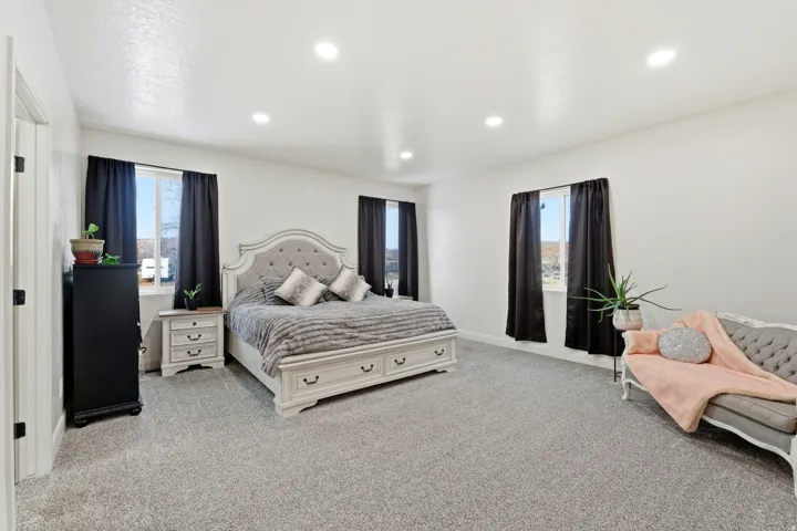 Bedroom featuring light colored carpet and recessed lighting