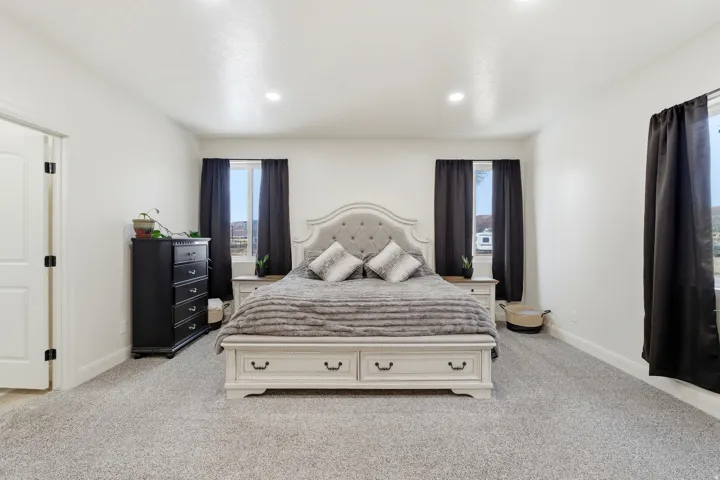 Bedroom with light carpet and recessed lighting