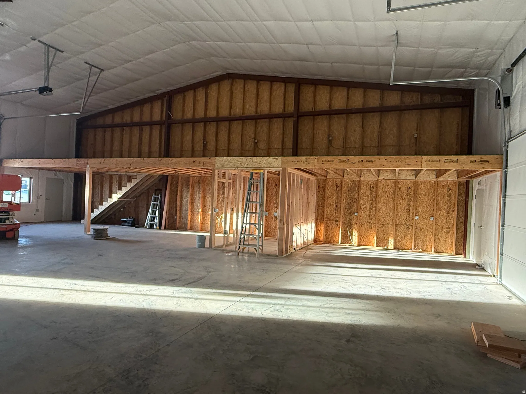 Misc room with a garage and a high ceiling