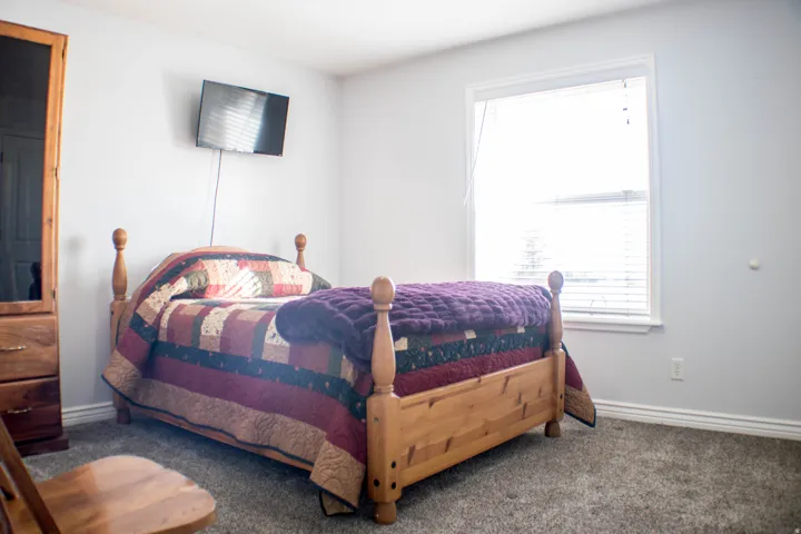 Carpeted bedroom with baseboards