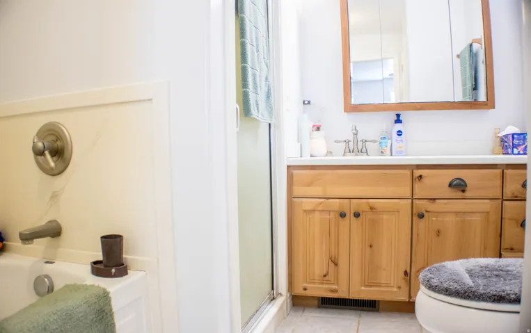 Full bath with vanity, an enclosed shower, a tub to relax in, and light tile patterned floors