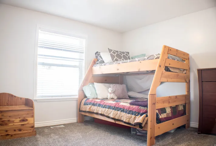 Carpeted bedroom with baseboards