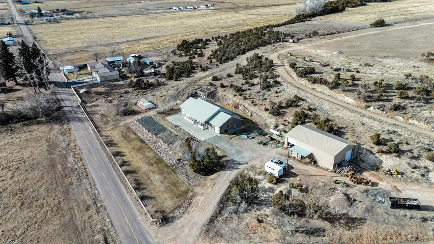 Aerial view of property and surrounding area featuring rural landscape