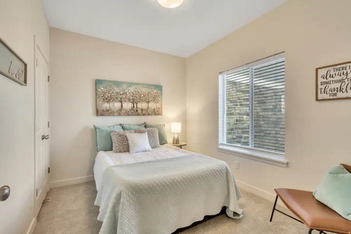 Carpeted bedroom featuring baseboards