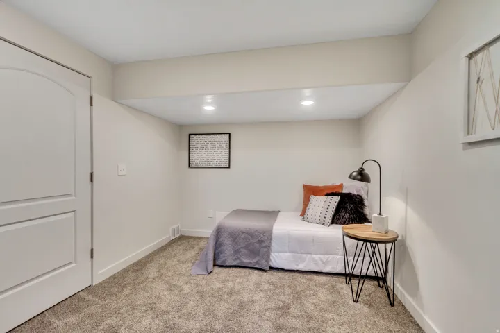 Carpeted bedroom with baseboards and recessed lighting