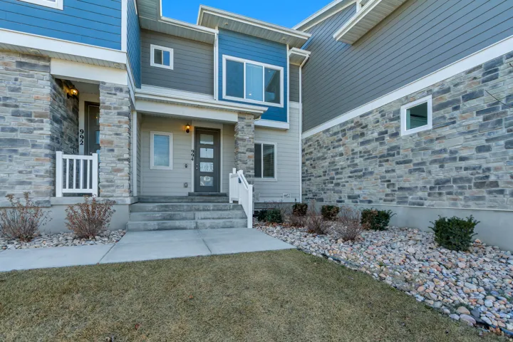 Entrance to property with a lawn and covered porch
