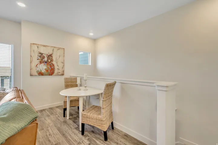 Dining area with light wood-type flooring and recessed lighting
