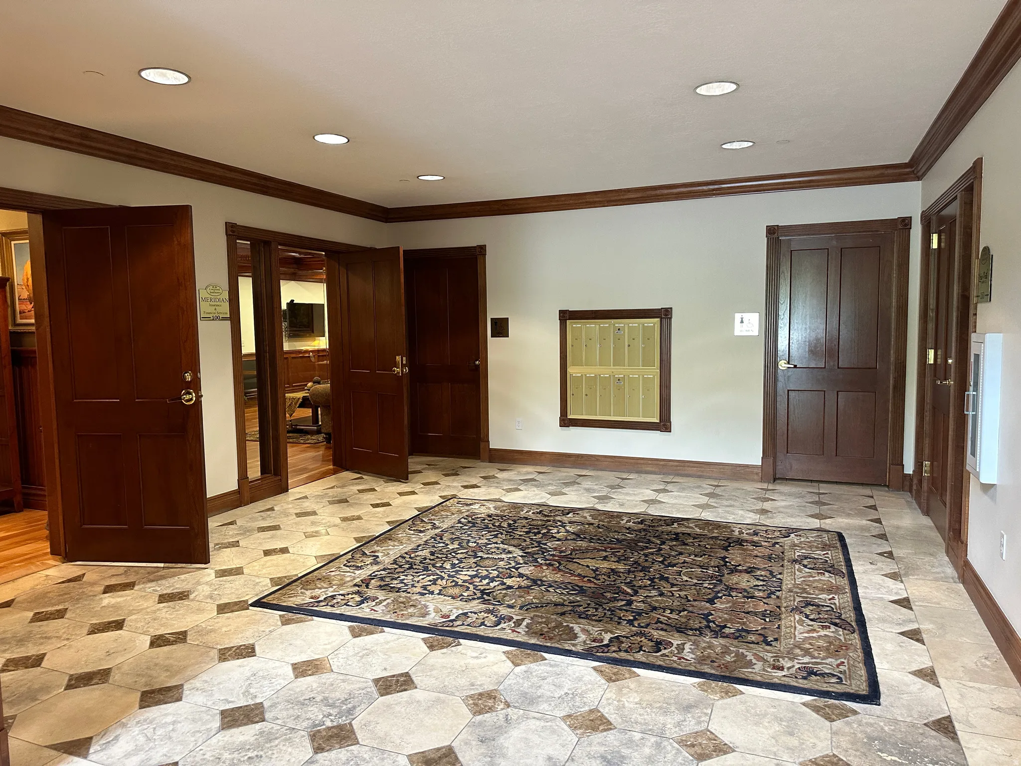 Foyer with crown molding and recessed lighting