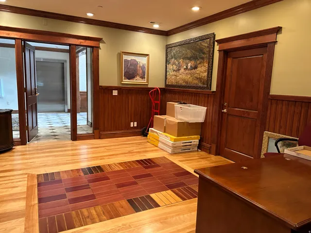 Unfurnished office with a wainscoted wall, light wood-type flooring, ornamental molding, and recessed lighting