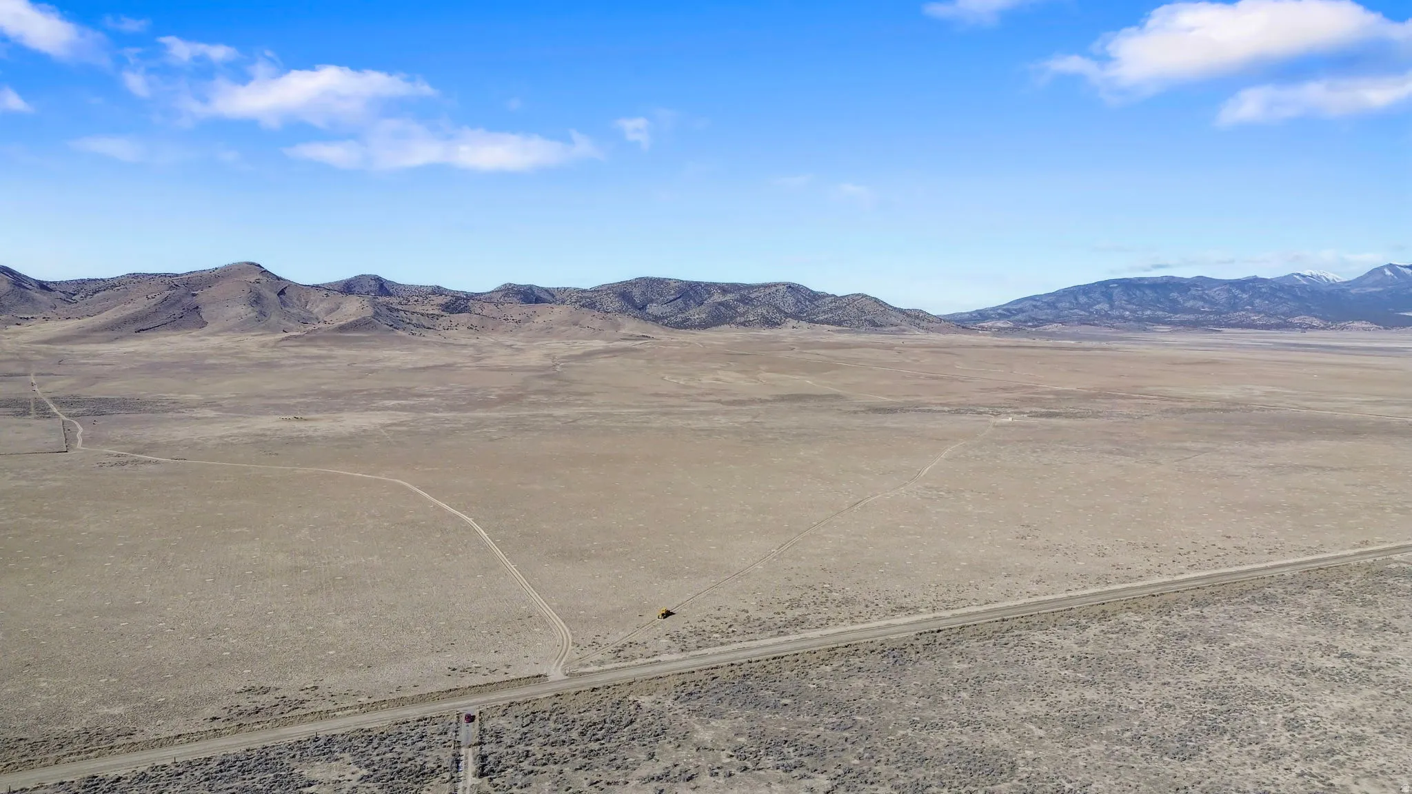 View of mountain backdrop with rural landscape and a desert landscape