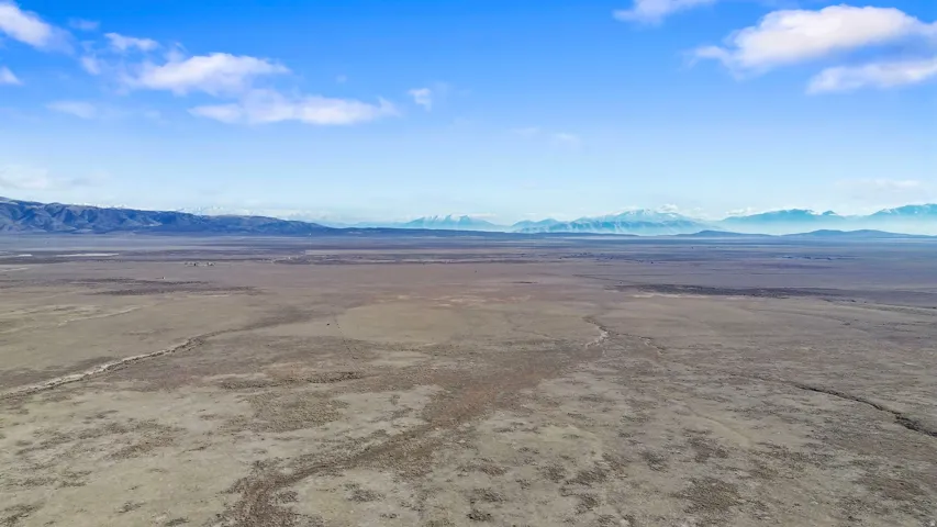 Aerial view of sparsely populated area featuring a mountainous background and a desert landscape
