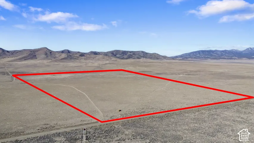 Aerial overview of property's location featuring a mountain backdrop and property parcel outlined
