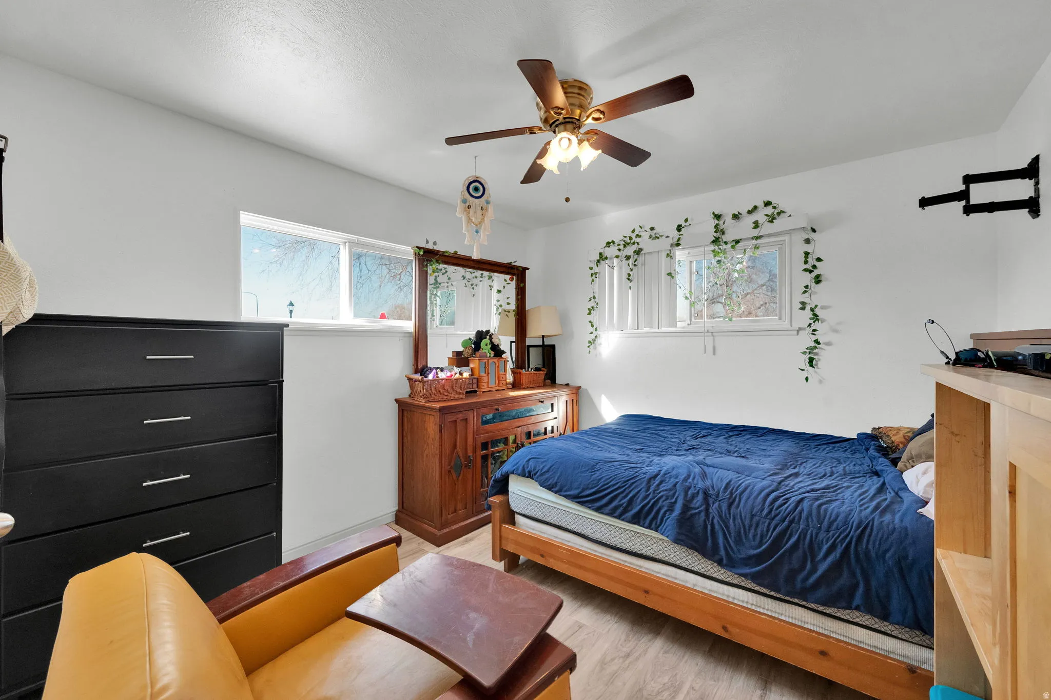 Bedroom with ceiling fan and light wood-style floors