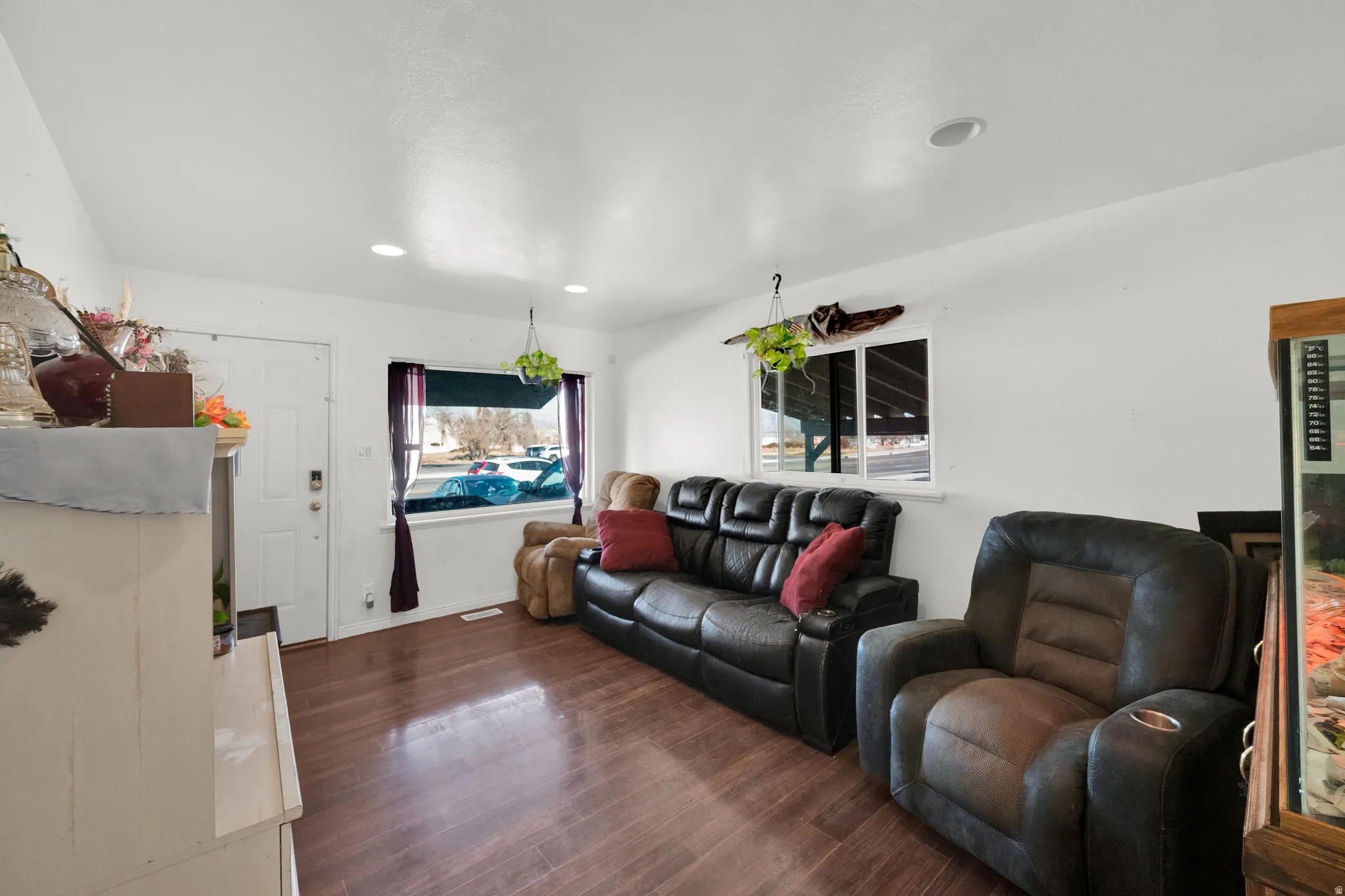 Living area featuring dark wood finished floors and recessed lighting