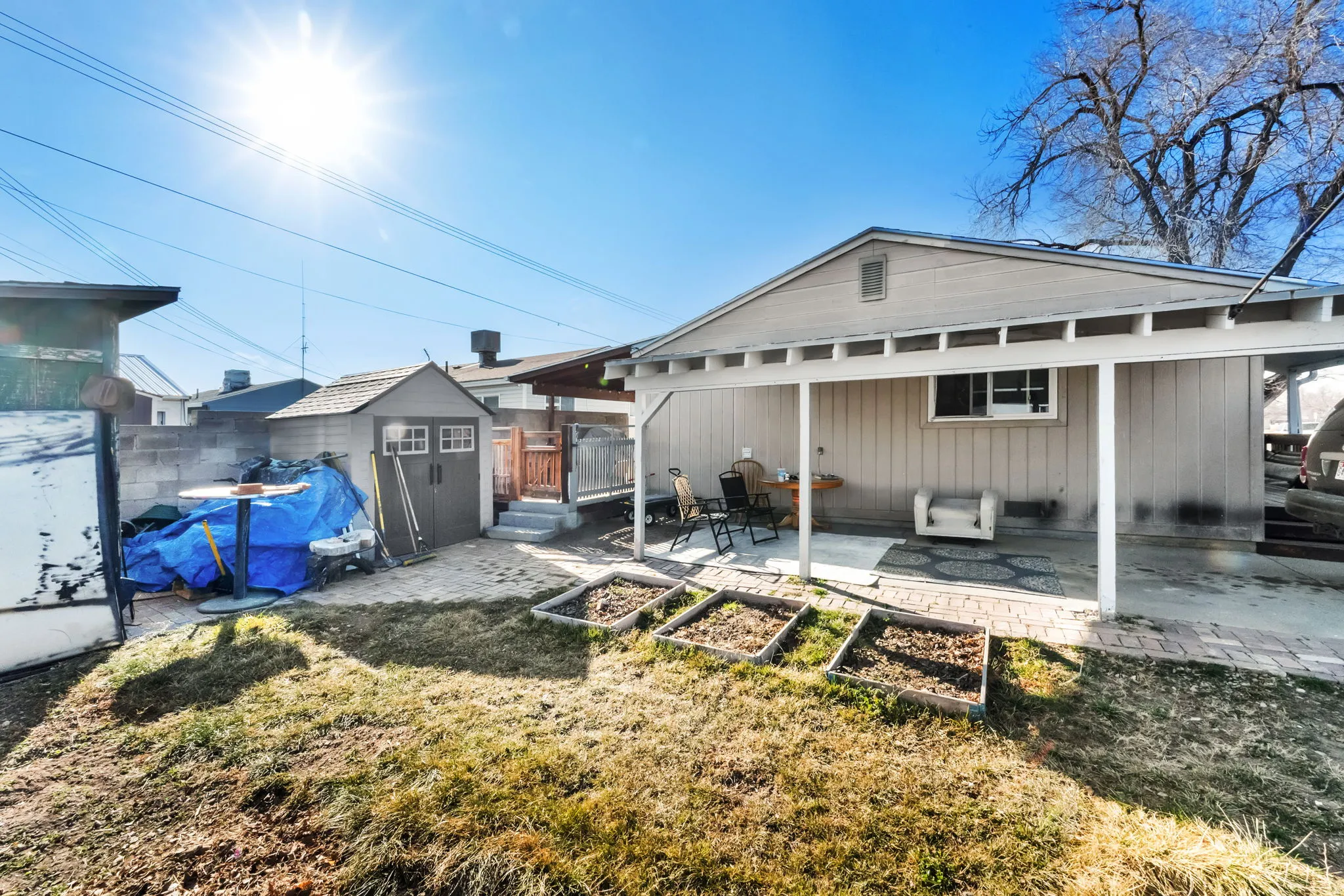 Back of house with a shed, a patio, and a fenced backyard