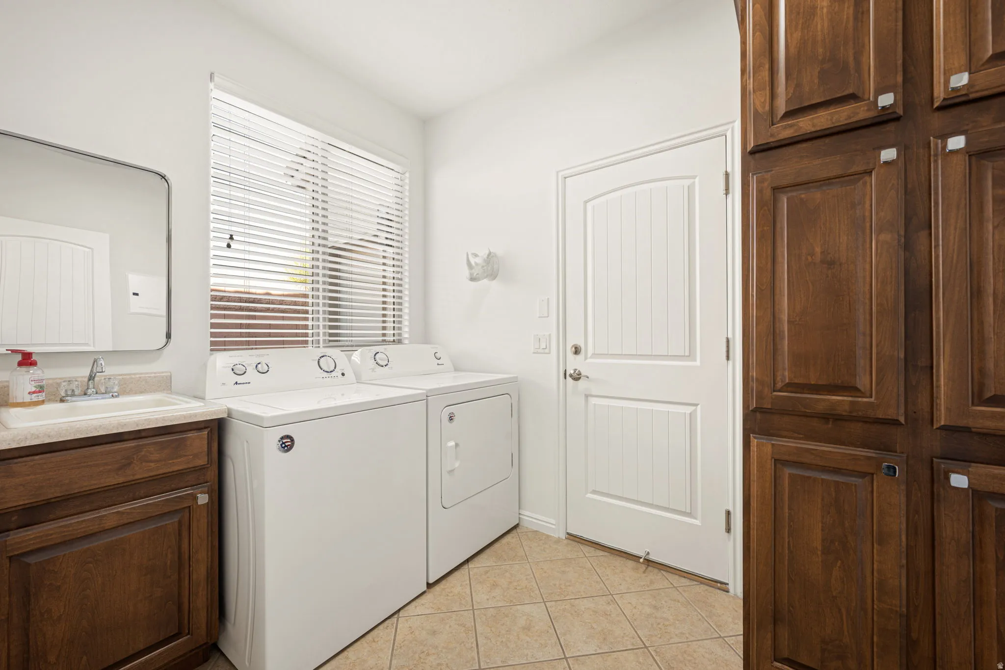 Laundry room with sink and storage
