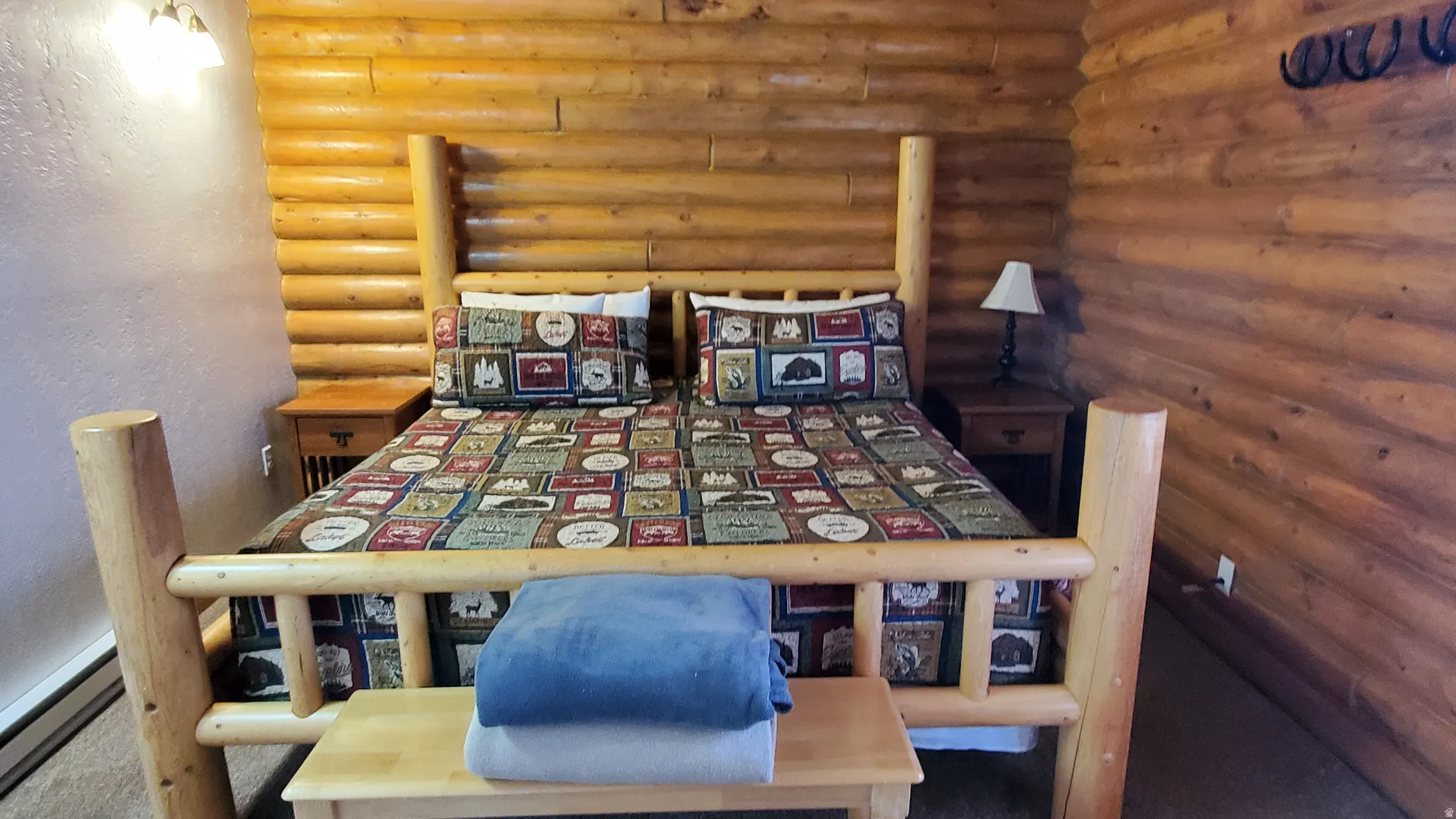 Dining room with log walls, a textured wall, and baseboard heating