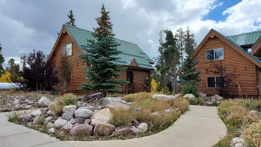 View of side of property with log exterior and a metal roof