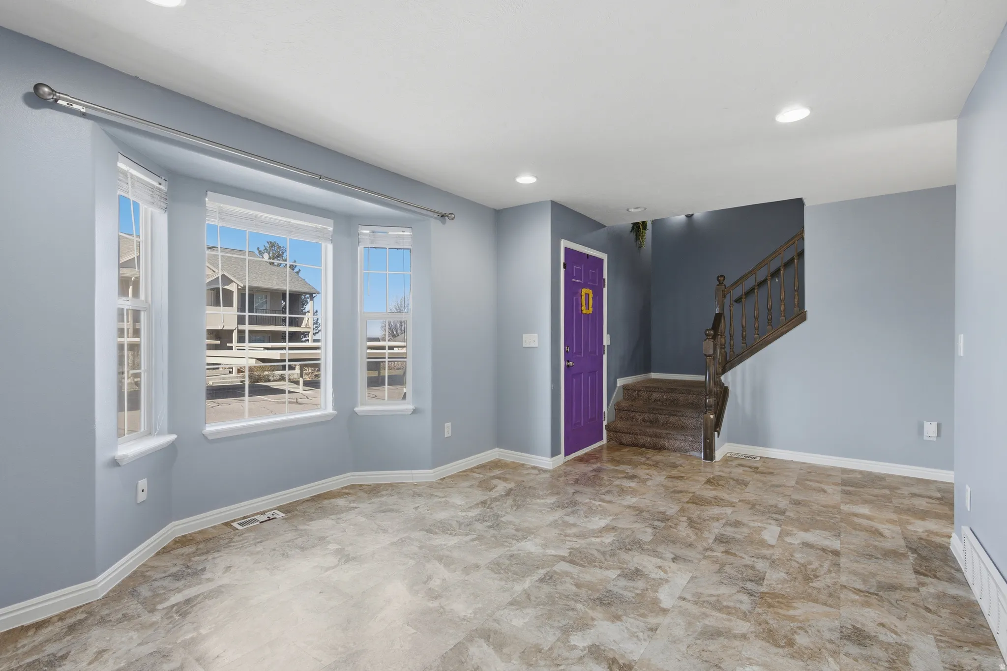 Entrance foyer with stairs and recessed lighting
