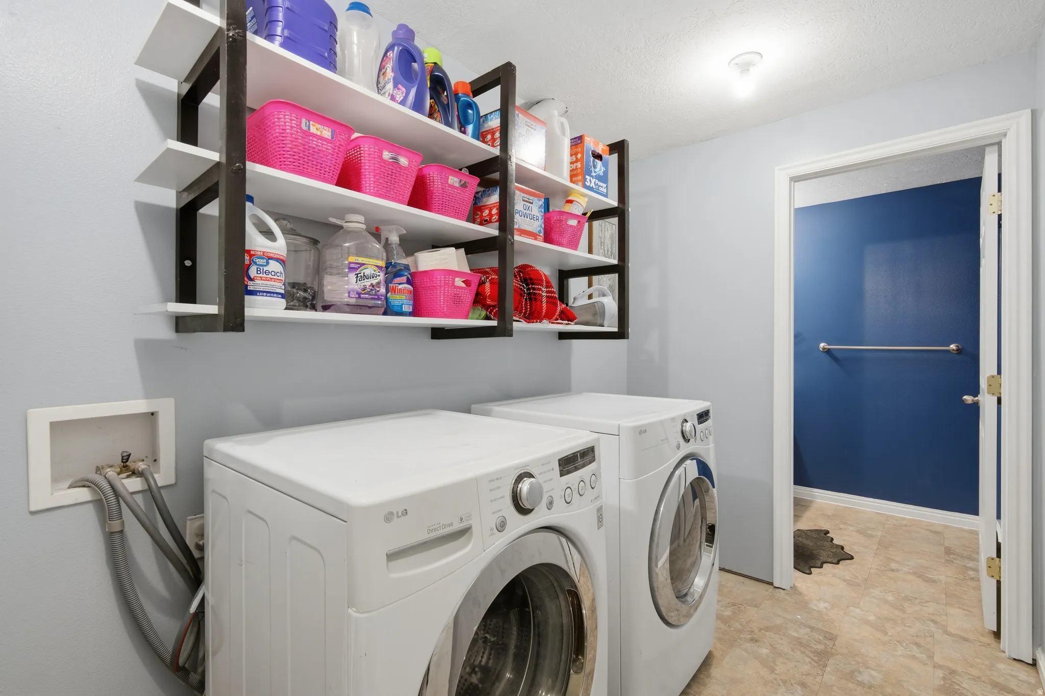 Washroom featuring independent washer and dryer and baseboards