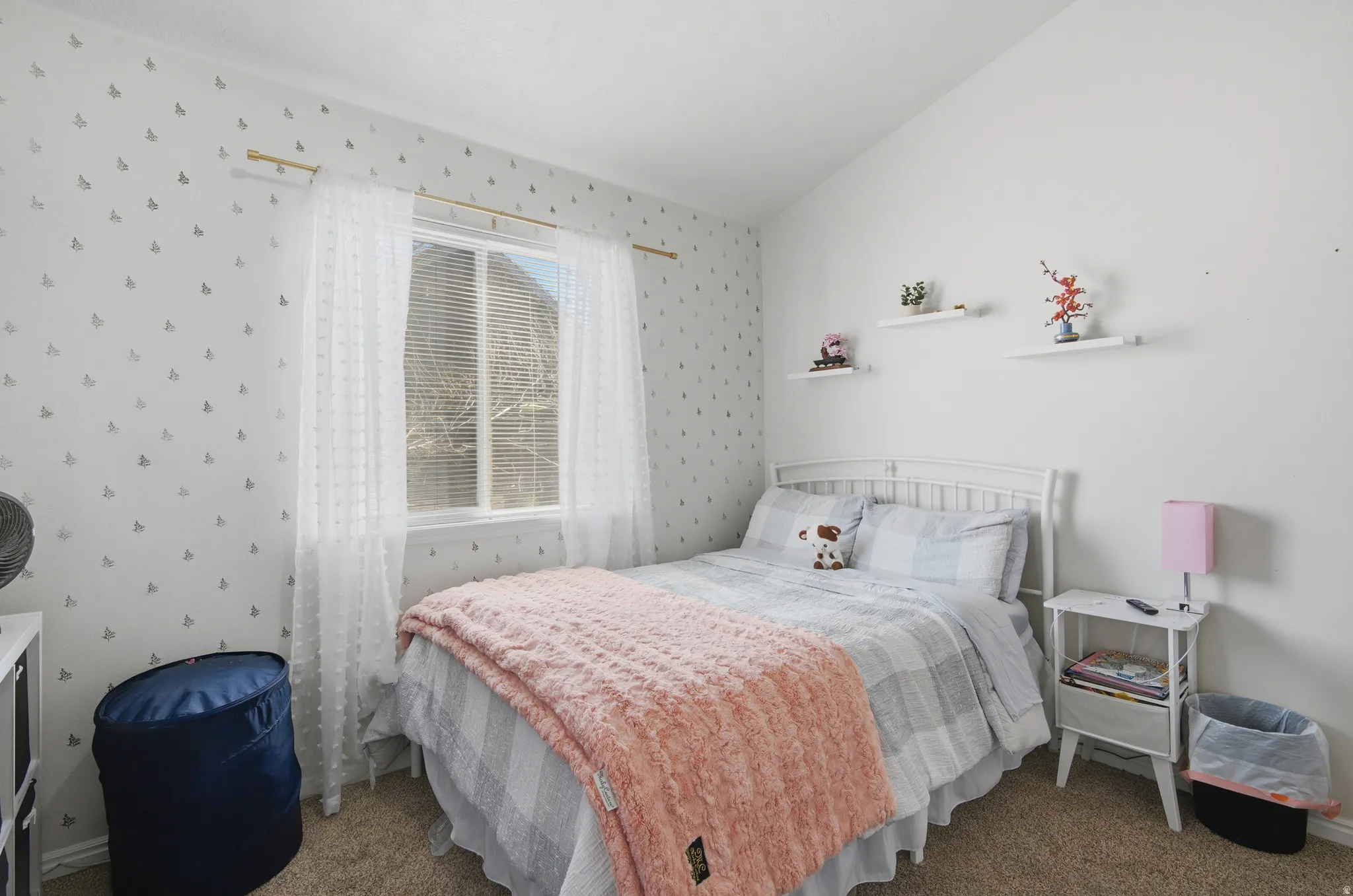 Carpeted bedroom featuring lofted ceiling