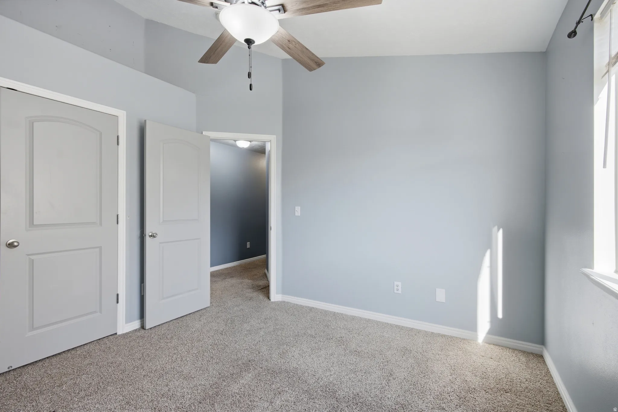 Bedroom featuring carpet floors and ceiling fan