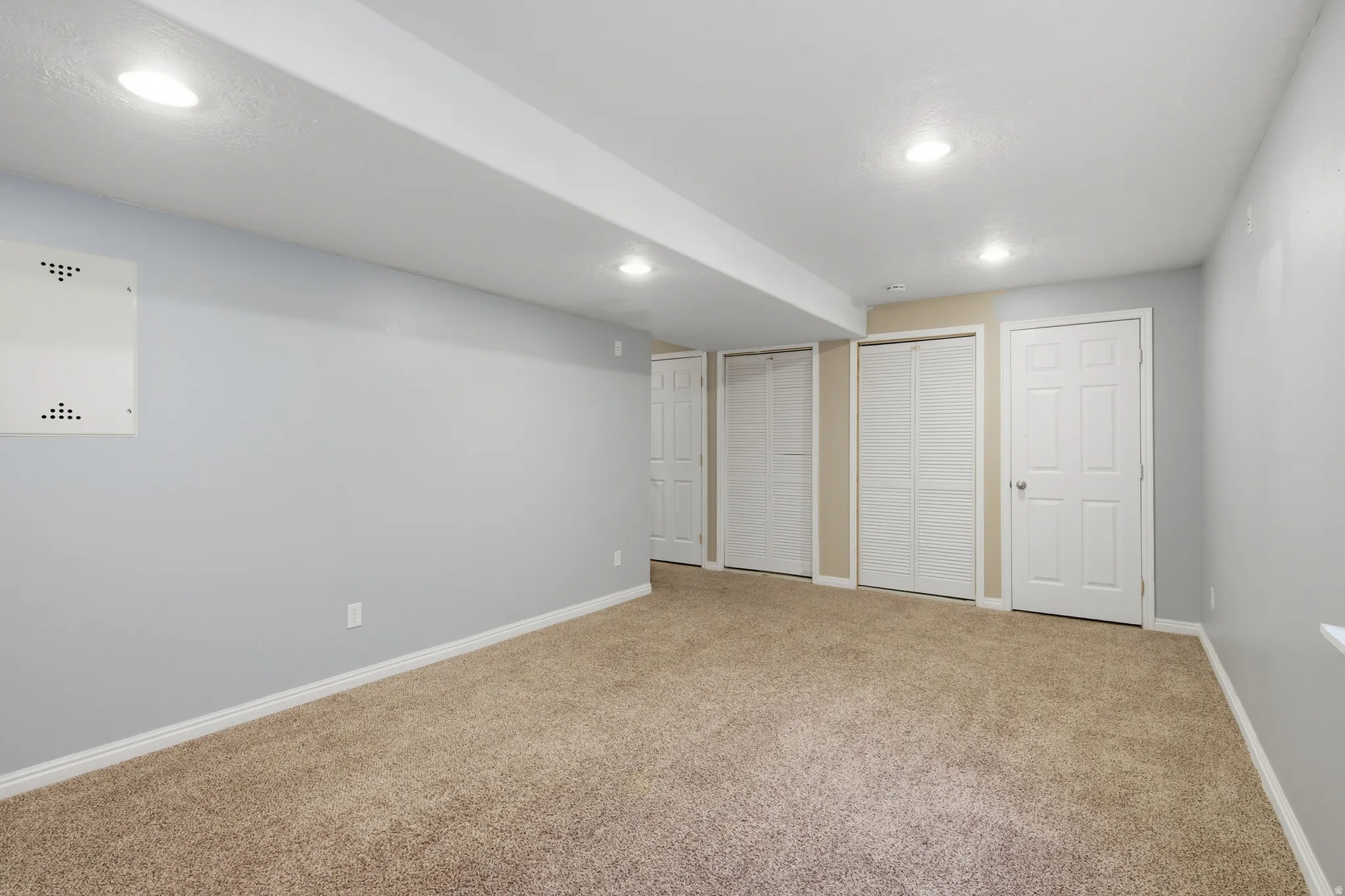 Family room  featuring two closets, carpet flooring, and recessed lighting