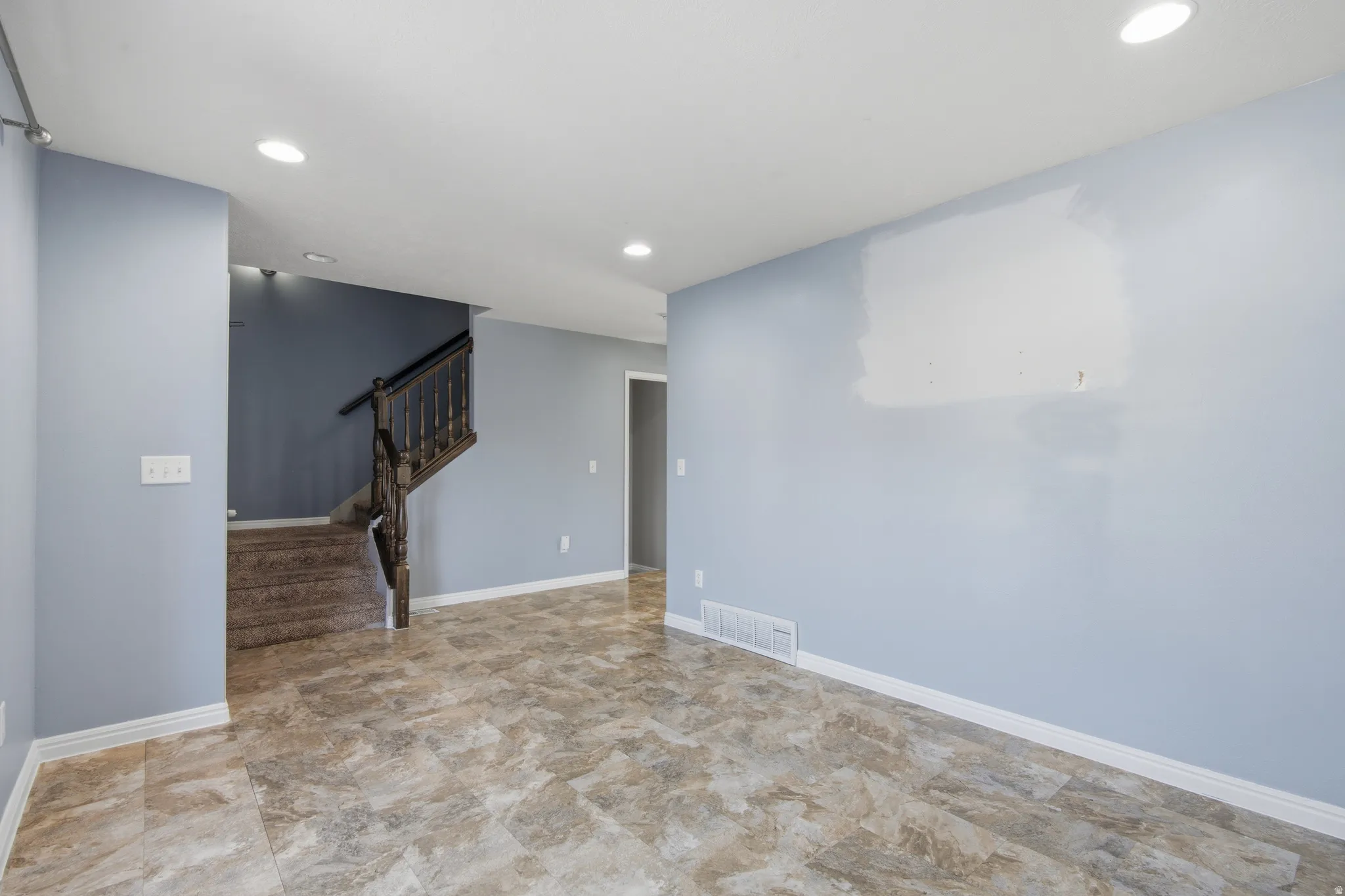Living  room featuring stairway and recessed lighting