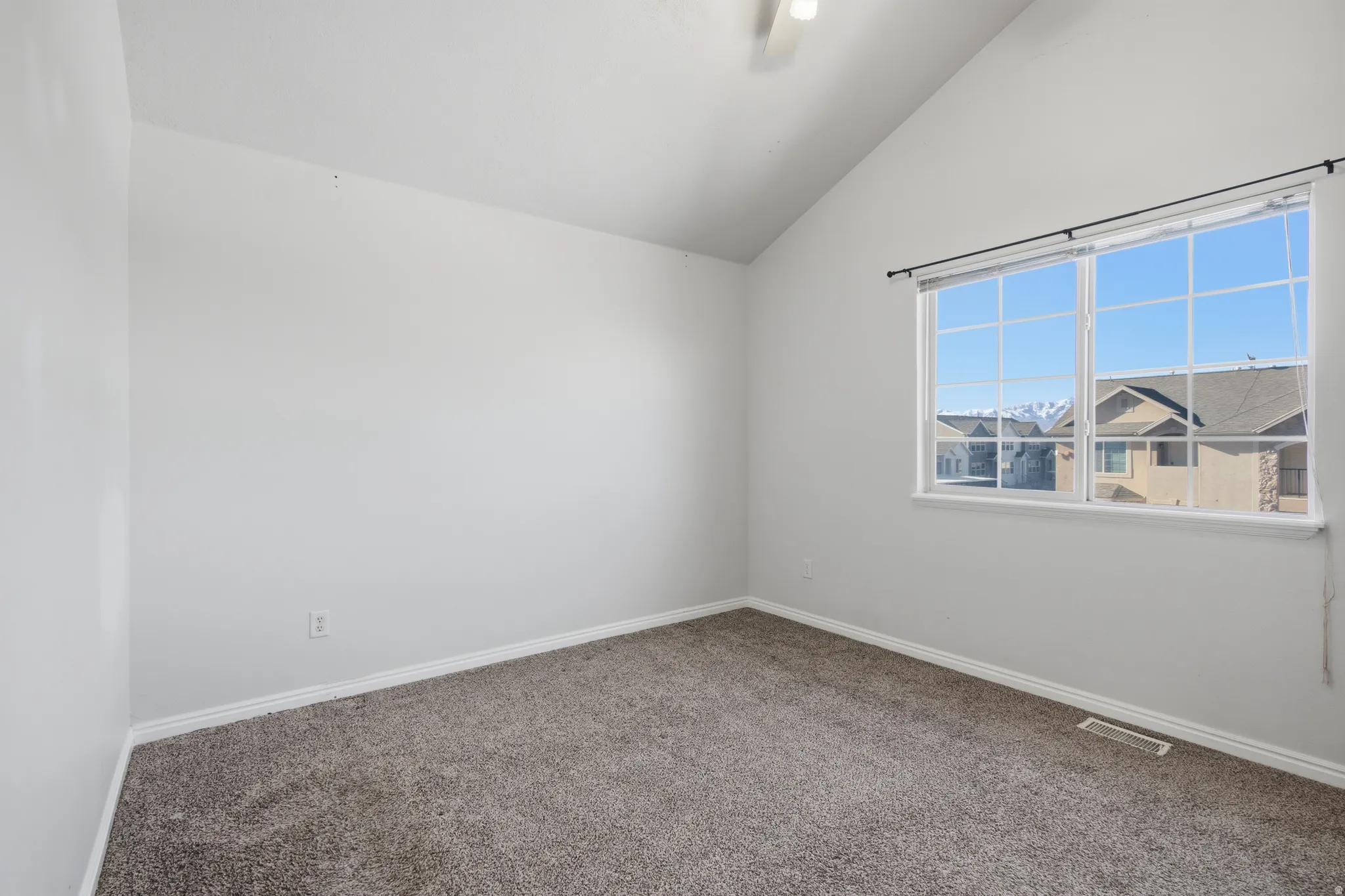 Primary Bedroom featuring lofted ceiling and carpet floors