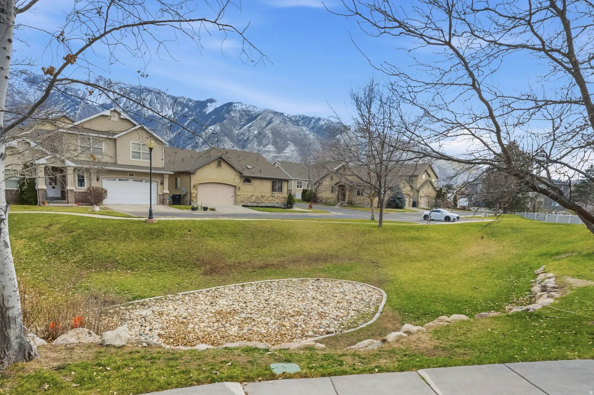 View of grassy yard featuring a mountain view and a residential view