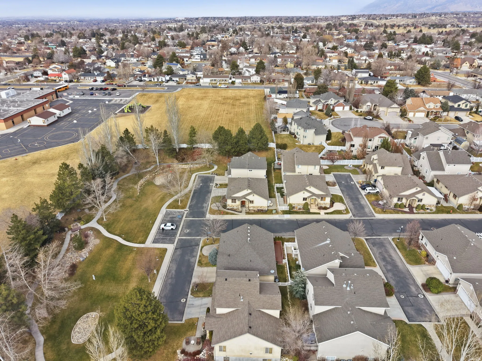 Aerial view of property and surrounding area featuring nearby suburban area