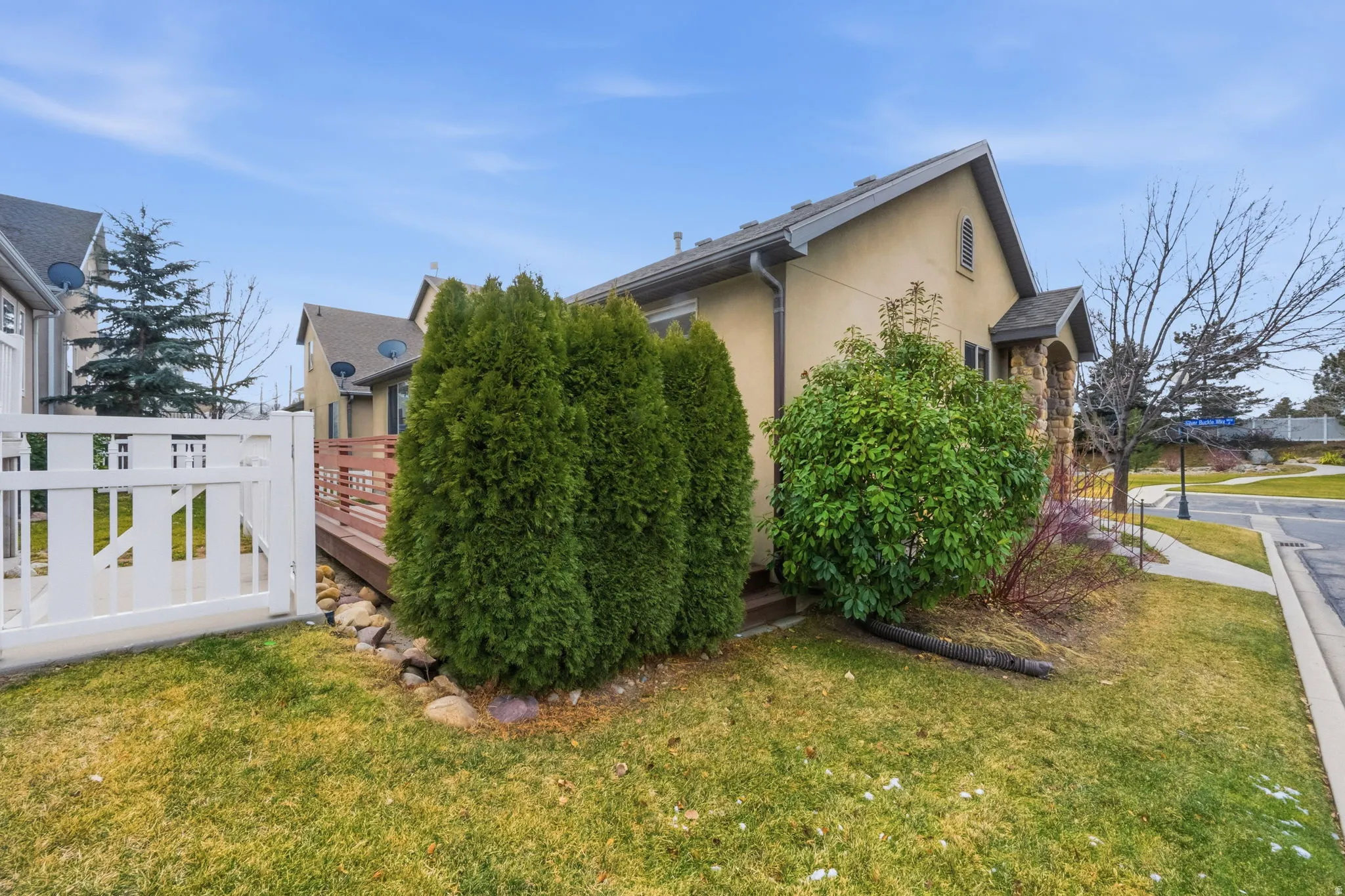 View of property exterior featuring stucco siding and a deck