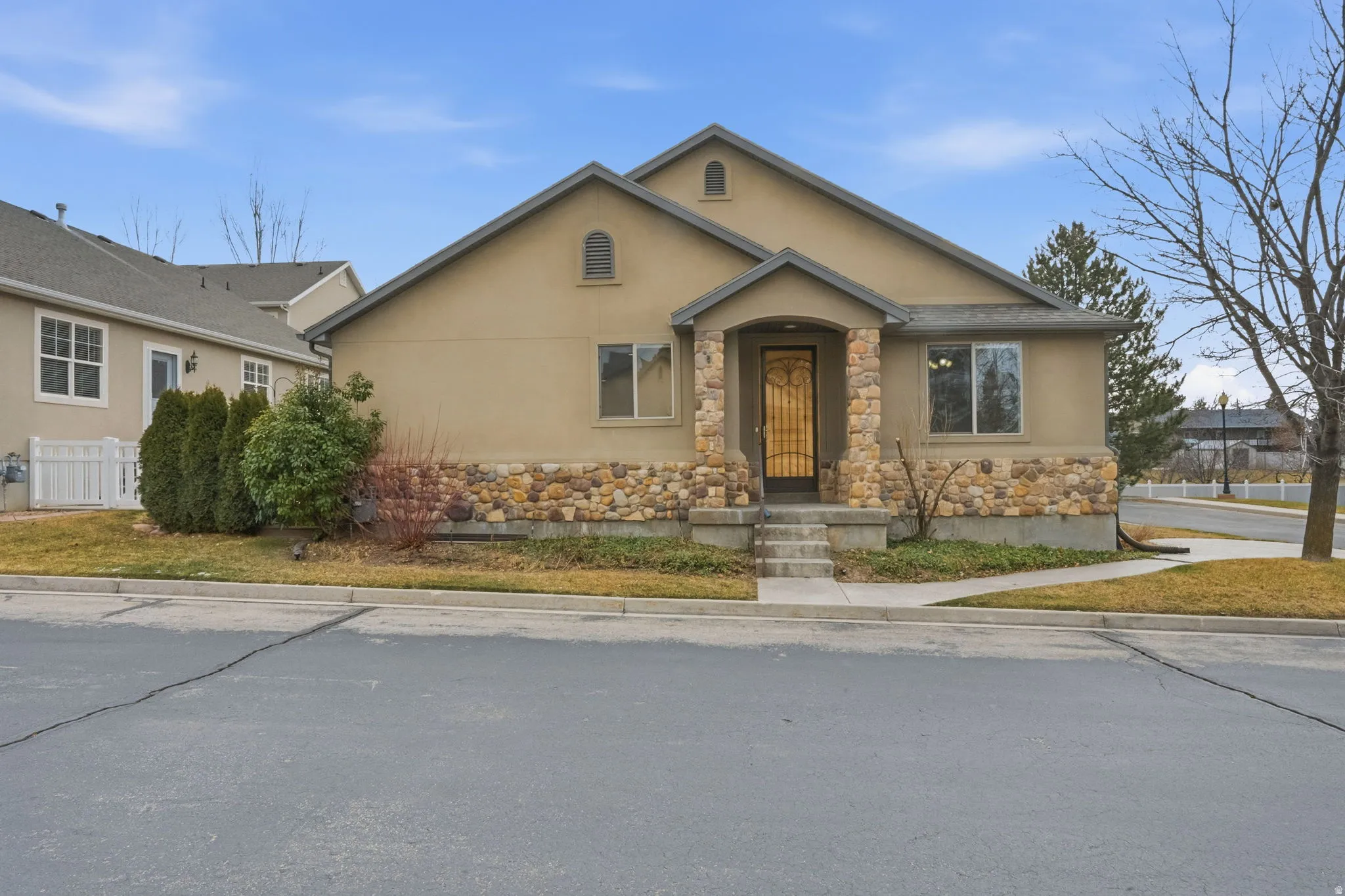 View of front of home with stone siding and stucco siding