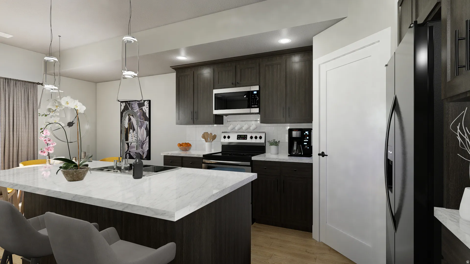 Kitchen with a breakfast bar, pendant lighting, light wood-type flooring, appliances with stainless steel finishes, and a kitchen island with sink