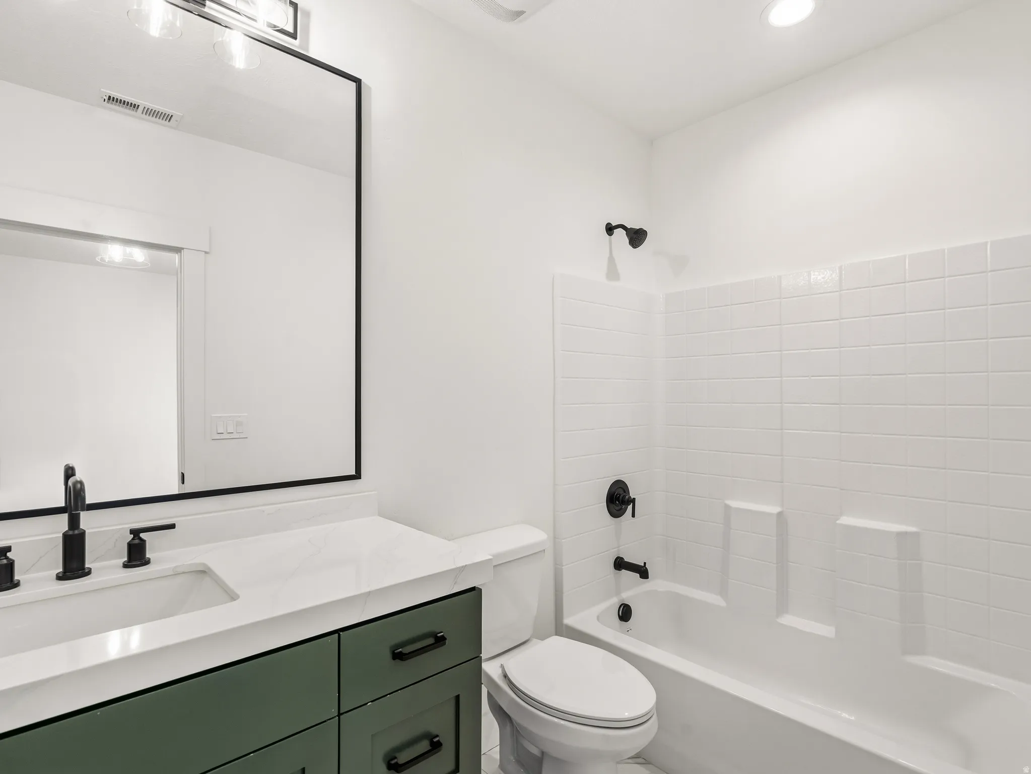 Primary bathroom with bathing tub / shower combination and vanity in the ADU