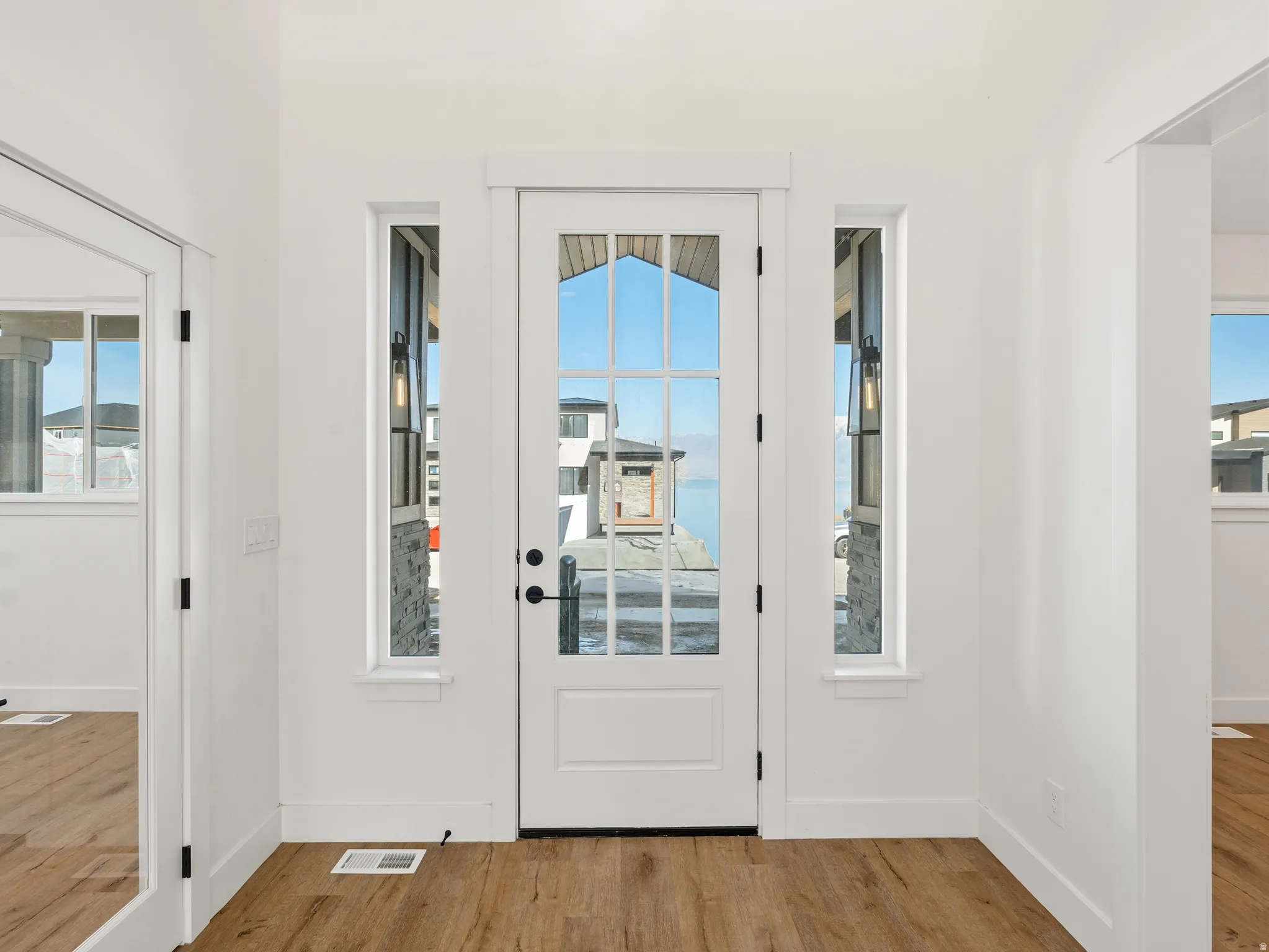 Entryway with light wood-style floors and plenty of natural light
