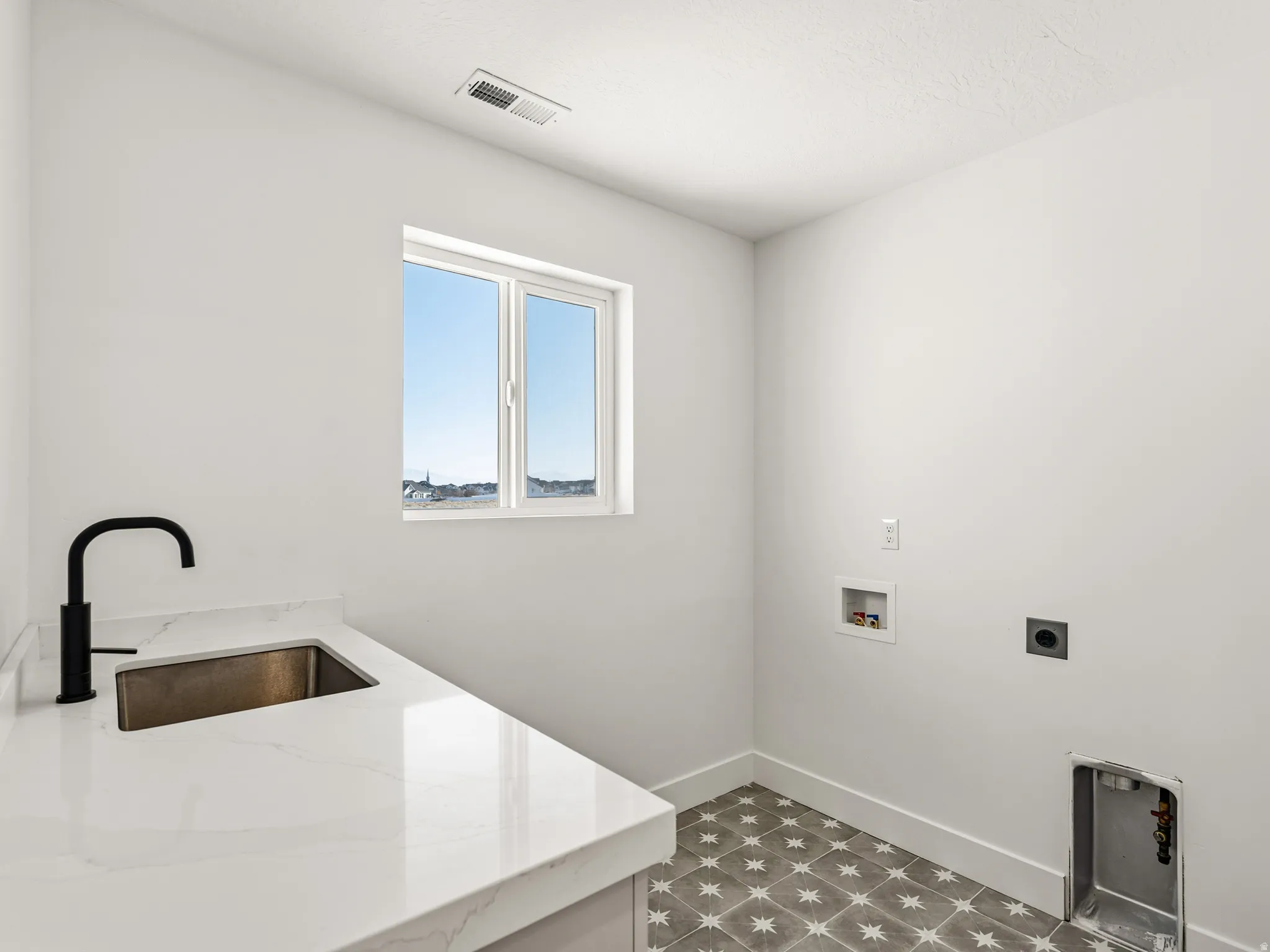Laundry room with washer hookup, tile floors, and electric dryer hookup