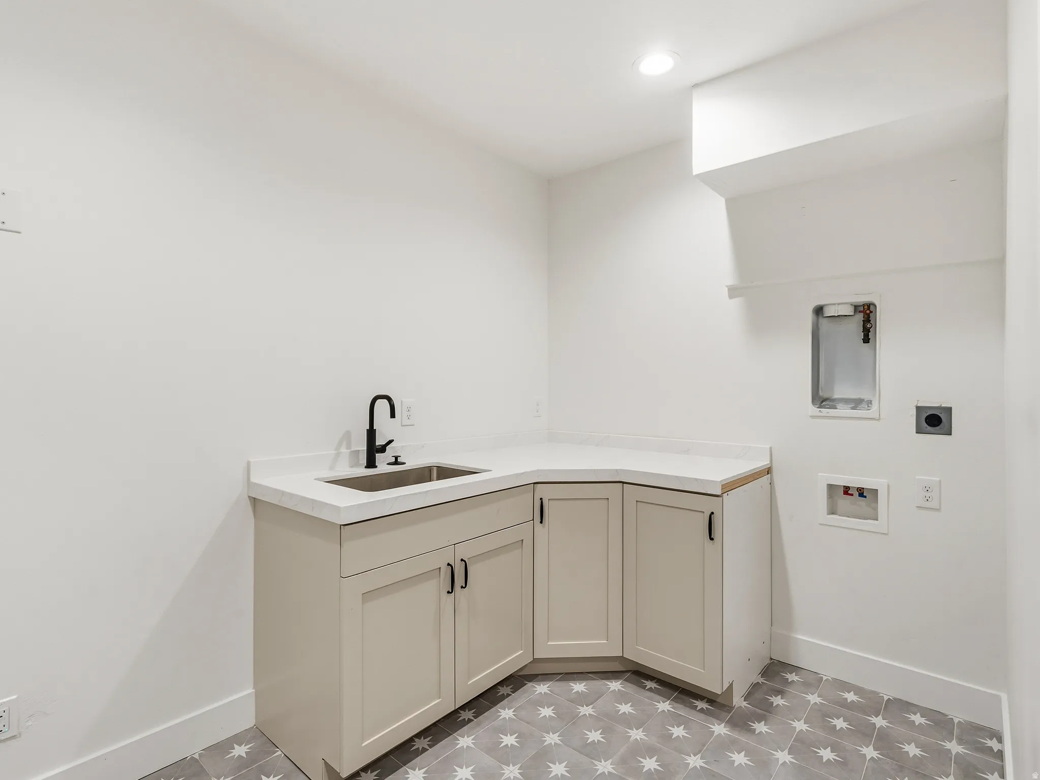 Laundry area featuring hookup for a washing machine, cabinet space, light flooring, and recessed lighting