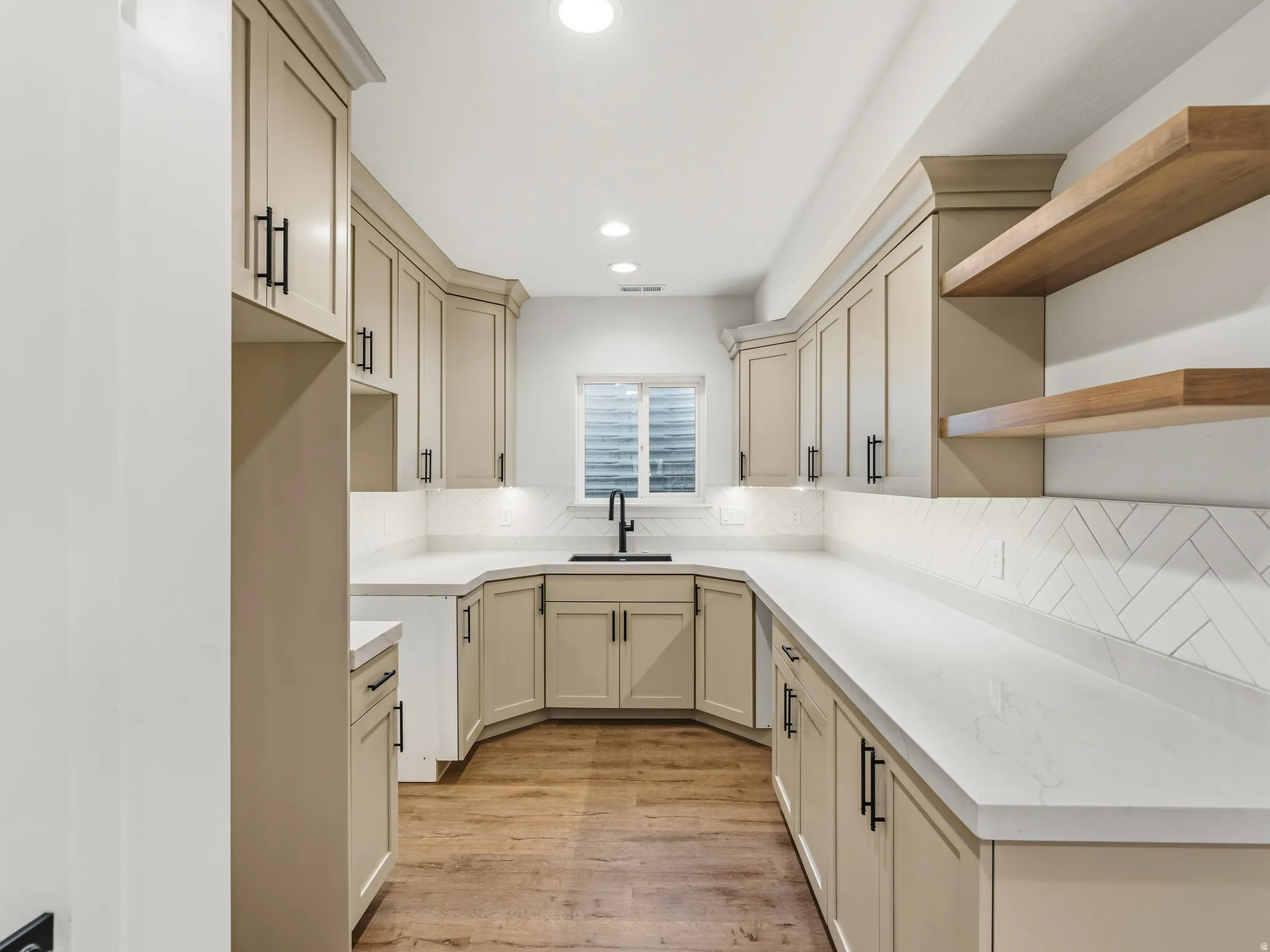 Kitchen featuring cream cabinetry, decorative backsplash, open shelves, light wood-type flooring, and recessed lighting